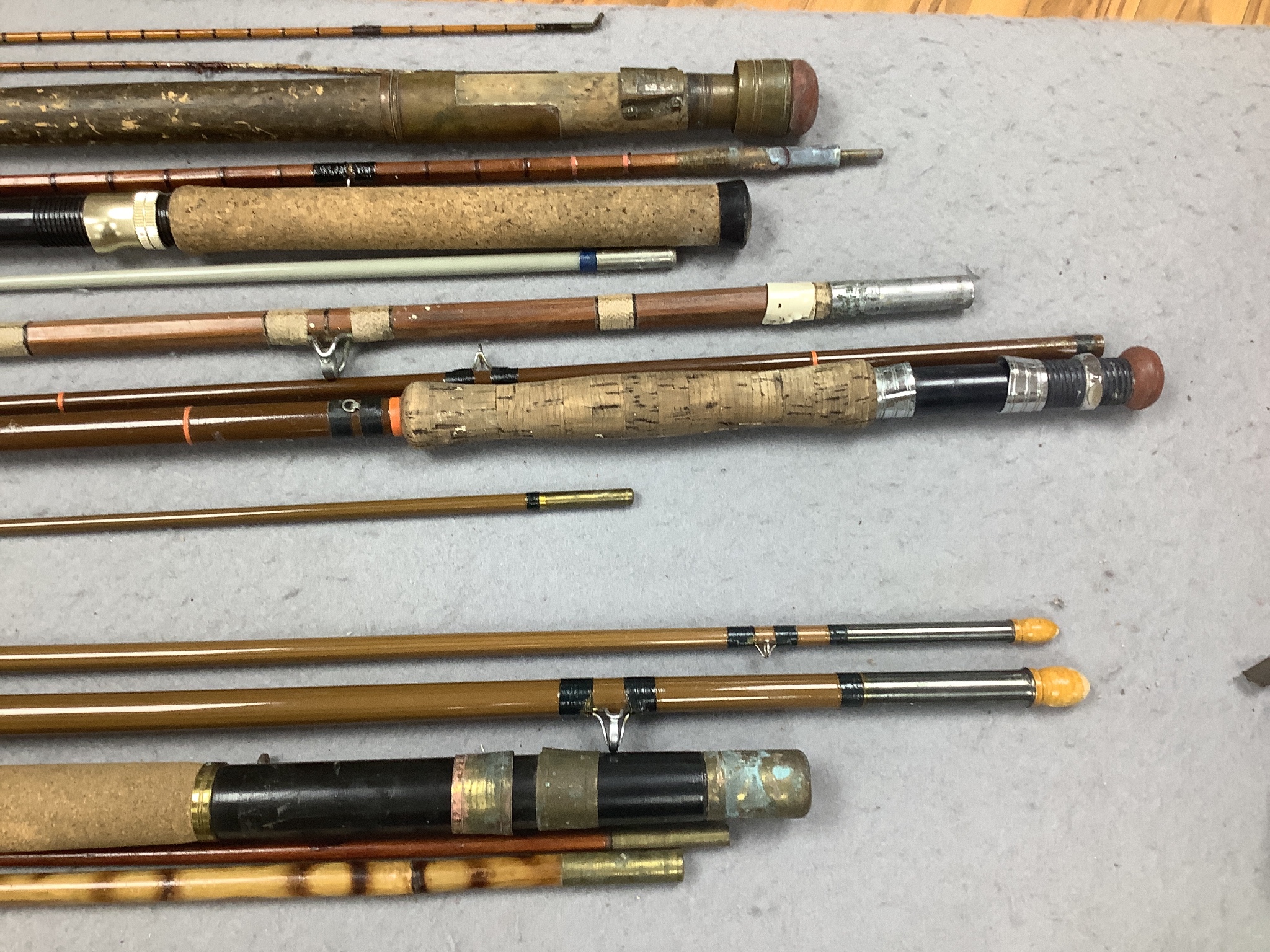 A quantity of fishing rods in fabric sleeves (6)